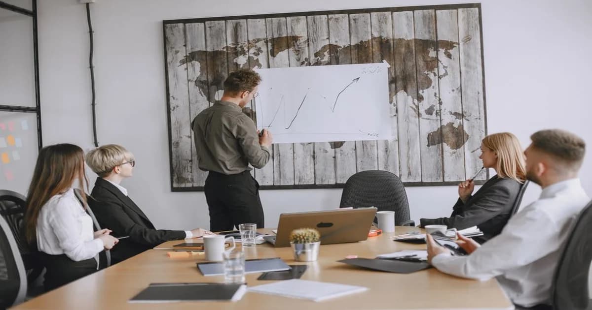 Gerente revisando documentos y gráficos sobre una mesa de trabajo para preparar su caso de ascenso