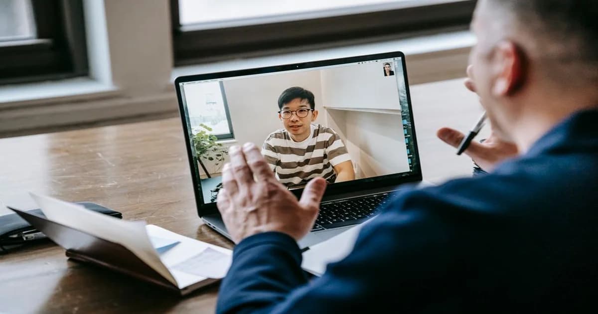 Gerente en reunión recibiendo orientación de un mentor, mientras otro líder ejecutivo observa desde lejos